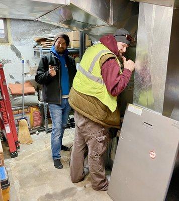 Sam & Shawn assess the old furnace that will be replaced.