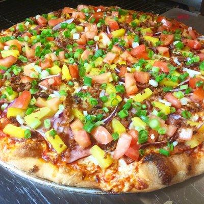 Maui Pizza "Spicy Red Sauce, Mozzarella Cheese, Canadian Bacon, Smoked Crumbled Bacon, Red Onion, Pineapple, Tomatoes and Green Onions"