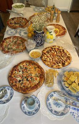 Margarita pizza, cheese pizza, bbq chicken pizza, veggie pizza and garlic bread