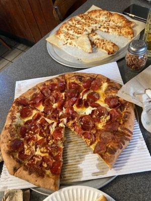 Large pepperoni with white sauce , half garlic and an order of cheese sticks .