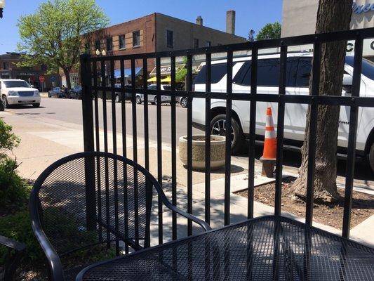 Behind the patio bars.