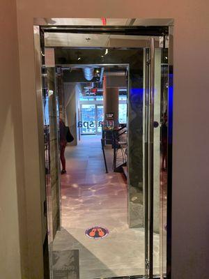 View from inside the aura spa at the glass door. See the main entrance doors to the gym in the back of the photo.