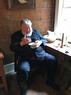 "Dr. Coffin" holding the bowl that showed the amount of blood that could safely be removed.