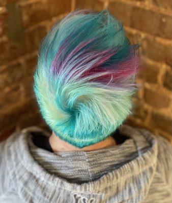 Shades of teal with a pop of pink on a pixie cut