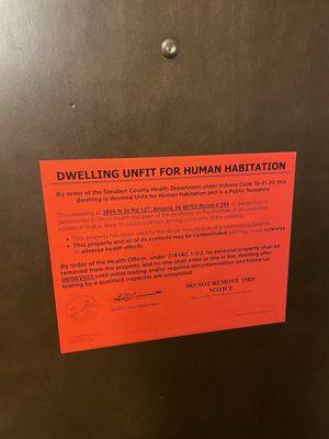 Sign posted on a room door