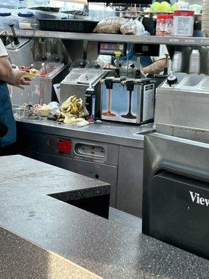 A big pile of banana peels on top of the counter instead of being in the trash.