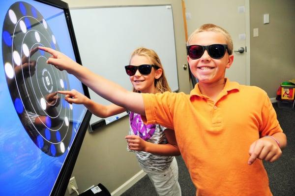 Two of our young vision therapy patients having fun on the Sanet Visual Integrator