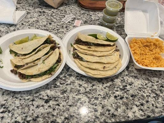 Tacos de asada corn and flor tortillas with a side of rice.