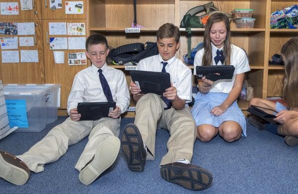 Students enjoying studying through the use of technology (iPads) at Rosarian Academy, a private school in downtown West Palm Beach, FL.