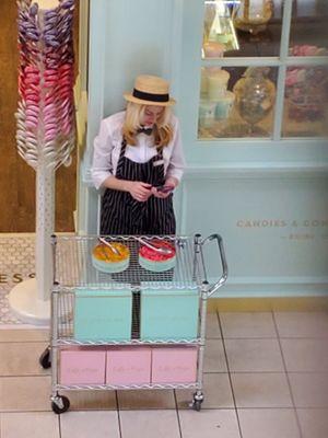 Hair down, over the samples and WHY is she texting on the job, in public? Manager issues apparently...