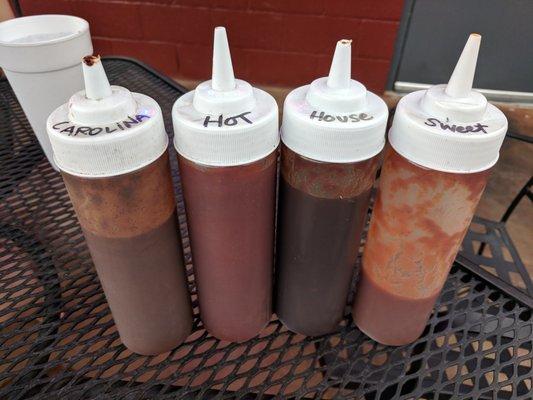 Left to right: Carolina, hot, house, and sweet BBQ sauces.