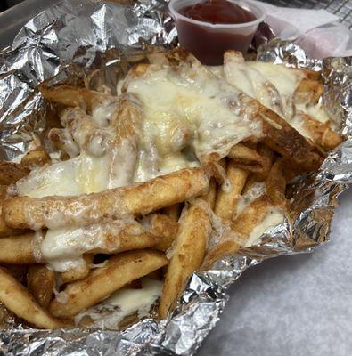 Cheese fries. (French fries with mozzarella, Parmesan and pecorino cheese) comes with ketchup