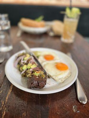 Grilled grass-fed hanger steak with charred poblano & tomatillo vinaigrette, avocado, fried eggs