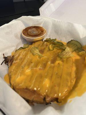 Brisket Sammich covered in queso and pickles