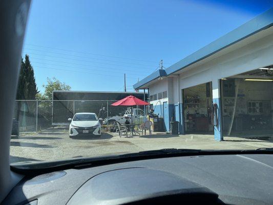 Little waiting area under the umbrella and more parking