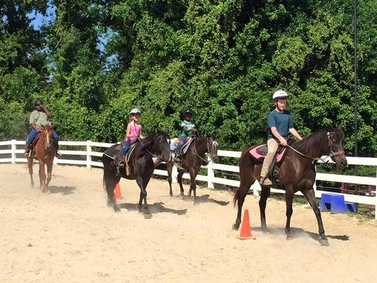 Kids having riding time at summer camp.