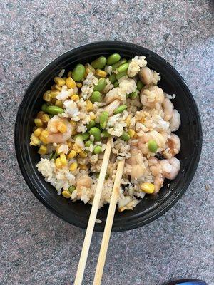 Sushi rice bowl with cooked shrimp, corn, onion, edamame, and poke sauce. Added some nori on top.