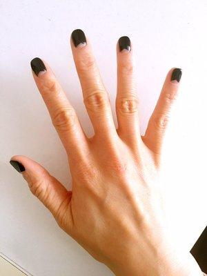 It's a clear fat and short triangle who's points start at the base corners of the nail and the remaining nail covered in black polish.