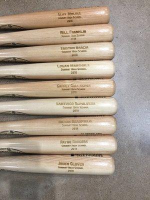 Baseball bats engraved for high school players.