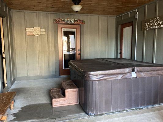 Screened porch area with hot tub