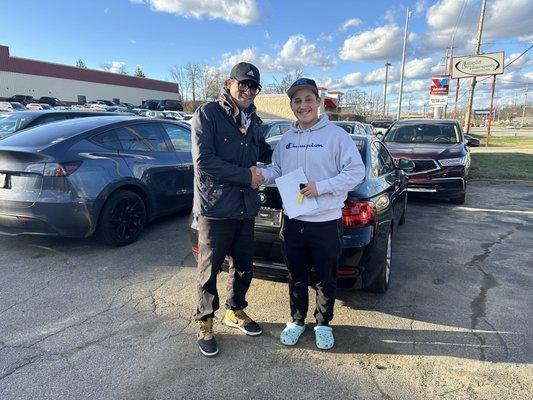 Salesman AJ and Sailor (my son) with his new car.