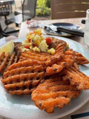 Mahi mahi with macadamia nut crust and a pile of sweet potato fries.