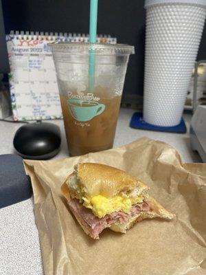 Plain bagel breakfast sandwich with ham, egg and cheese and medium white chocolate iced coffee with almond milk