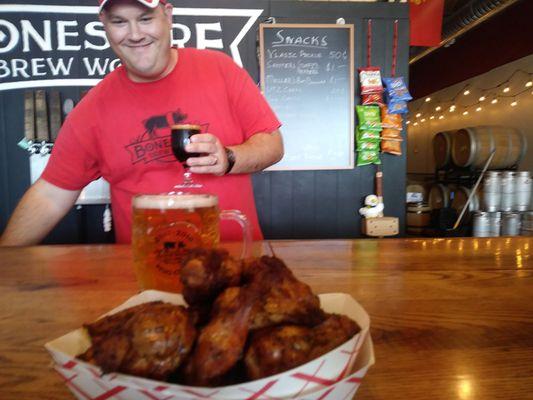 Hungry bartender admiring smoked wings.