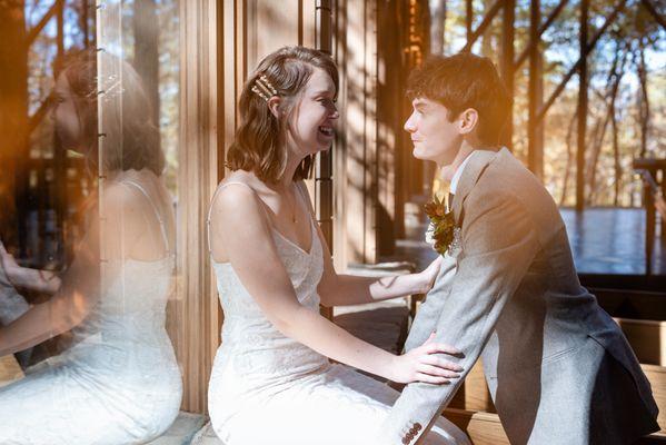 Loving gaze between bride and groom at their Anthony Chapel wedding in Hot Springs with forest reflections. Photo: Michele McCoy Photography