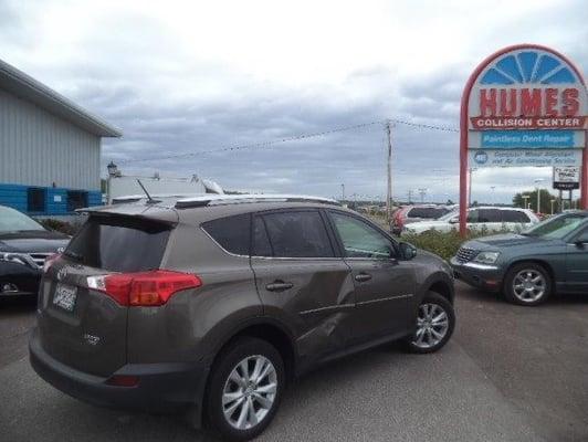 Dented side panel on Toyota Rav4.