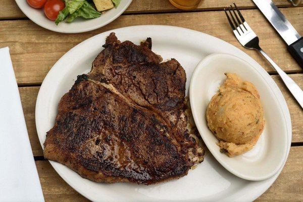 The Porterhouse! It's hard to get Porterhouse to their specs, but it's cut in house, so they serve this monster, 32 oz Porterhouse.