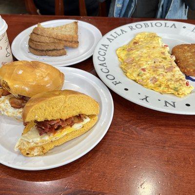 Bacon & Egg on a Egg Bagel Toasted with Hot Sauce.   Western Omelette