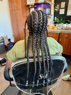 Long cornrows with beads.