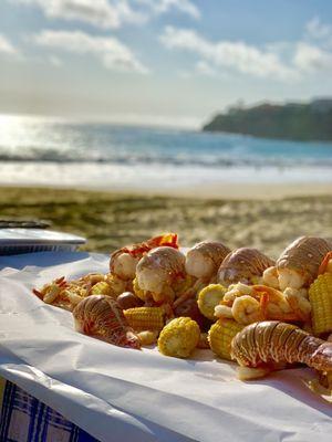 Beautiful presentation of Clambake OC's seafood bake on the beach.