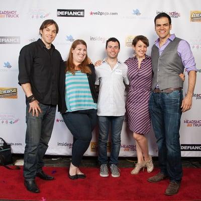 Our podcast team in front of the amazing step and repeat that Event Step and Repeat made for us!