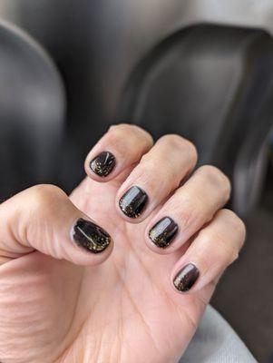 Black polish with a partial coat of gold sparkles (OPI, gel mani)