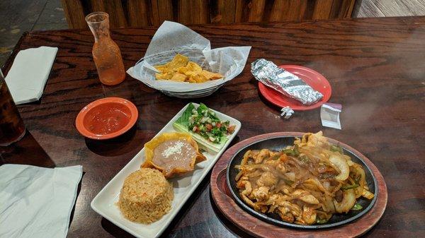 Lunch Chicken Fajitas with tortillas, chips, salsa beans rice and pico.