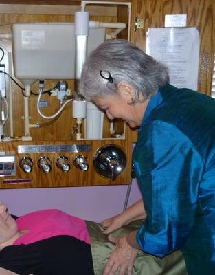 Joyce Long teaching a client about Colon Hydrotherapy