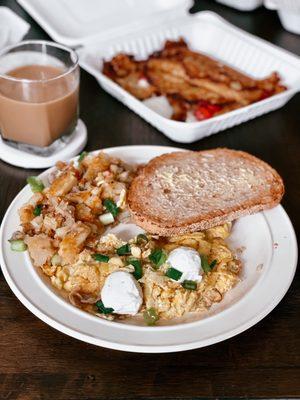 Gail's Favorite Eggs with side of Lyonnaise potatoes, and toast; strawberry pancake crepes in the back.