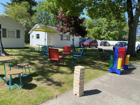 Park like setting with connect four, jenga and corn hole.