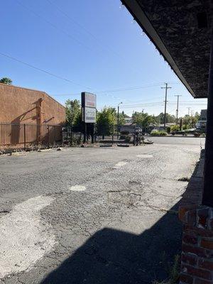 Entrance to private parking lot from street.