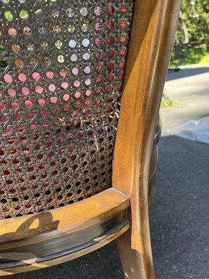 Although a moving blanket was wrapped around this chair and taped, Something bashed into it and crushed the wicker.