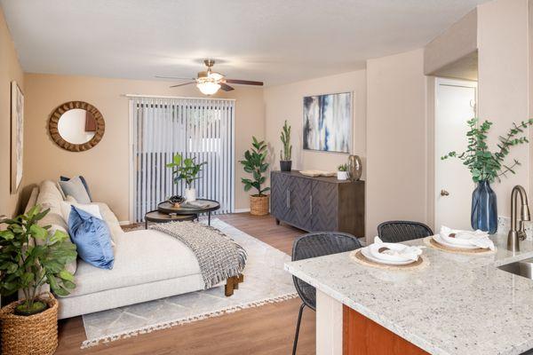 Living room with plank flooring and ceiling fan at The Palisades in Paradise Valley