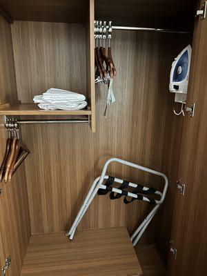 Closet with luggage rack and iron. I don't remember seeing an ironing board.