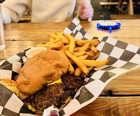 Double smash burgers with fries and sauce.