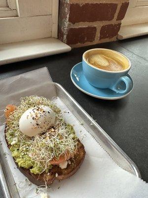 Avocado toasted with salmon and hot golden latte with shot of espresso