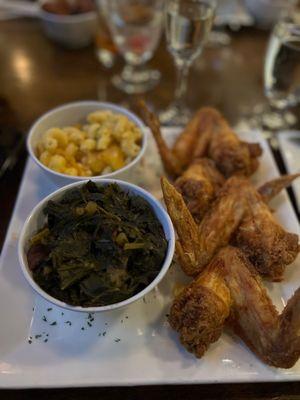 Fried chicken wings with collard greens and Mac and cheese.