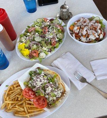 Greek salad, gyro over fries, and chicken and rice bowl.