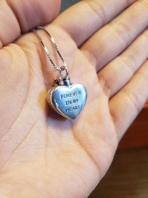 Back of necklace which reads "forever in my heart"