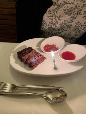 Chocolate mouse cake with strawberry reduction on the side. Added a candle for my birthday.